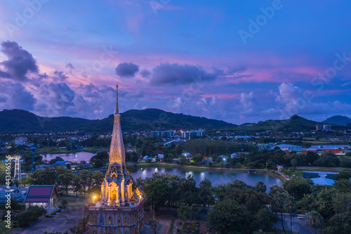 .aerial panorama view colorful cloud above pagoda of Chalong pagoda in twilight..beautiful architecture pagoda of Chalong temple in the night..colorful cloud scape sky sunset.