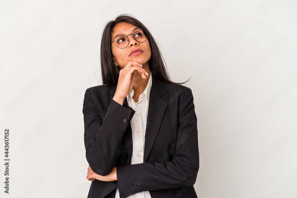 Young business latin woman isolated on white background looking sideways with doubtful and skeptical expression. Young business latin woman isolated on white background looking sideways with doubtful and skeptical expression.