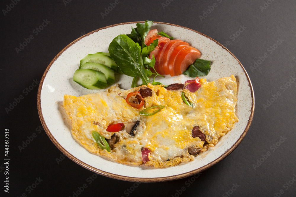 Omelet with vegetables, mushrooms and sausage in a plate Omelet with vegetables, mushrooms and sausage in a plate