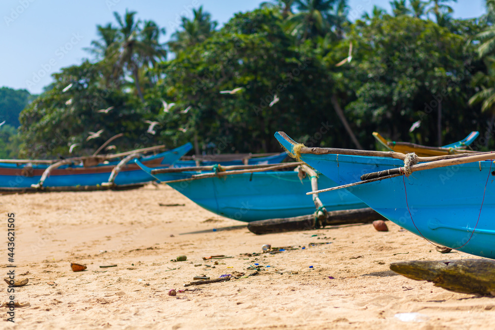 Wooden fishing boat on the ocean. Fishing village on the island Wooden fishing boat on the ocean. Fishing village on the island