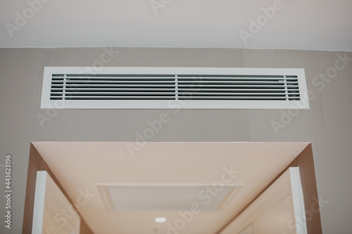 Conditioner air vent grill on the wall. photo