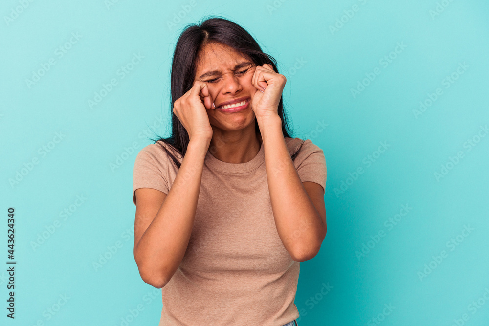 Young latin woman isolated on blue background whining and crying disconsolately. Young latin woman isolated on blue background whining and crying disconsolately.