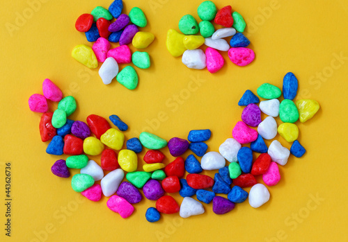 colored pebbles on yellow background