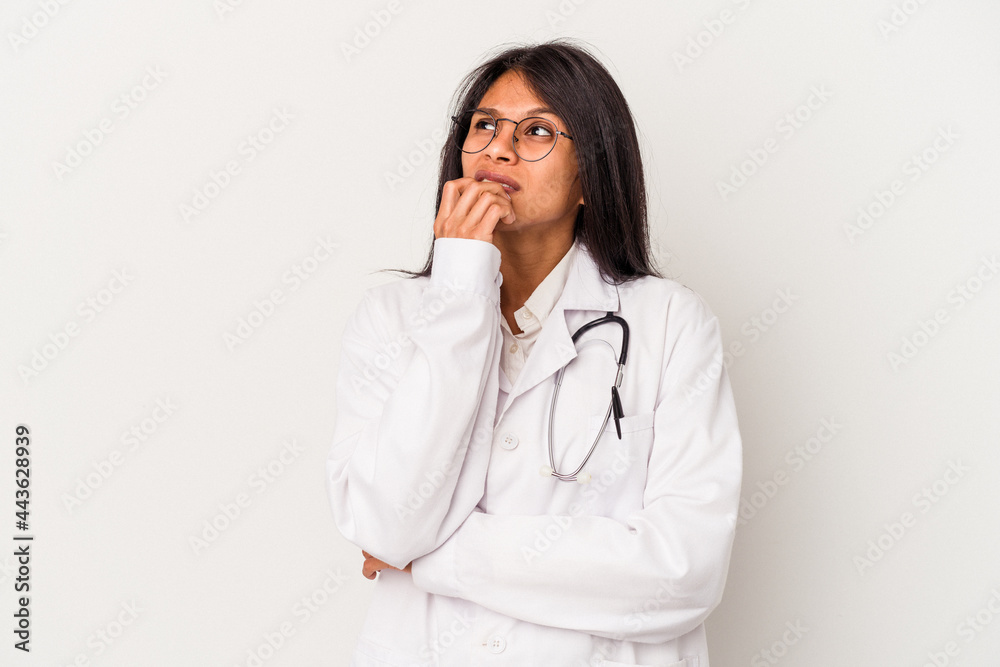 Young doctor latin woman isolated on white background relaxed thinking about something looking at a copy space. Young doctor latin woman isolated on white background relaxed thinking about something looking at a copy space.