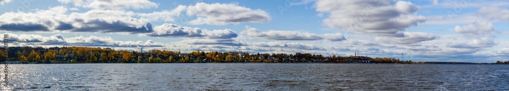 Panorama view of the city from the side of the river, autumn landscape. ultra wide photo