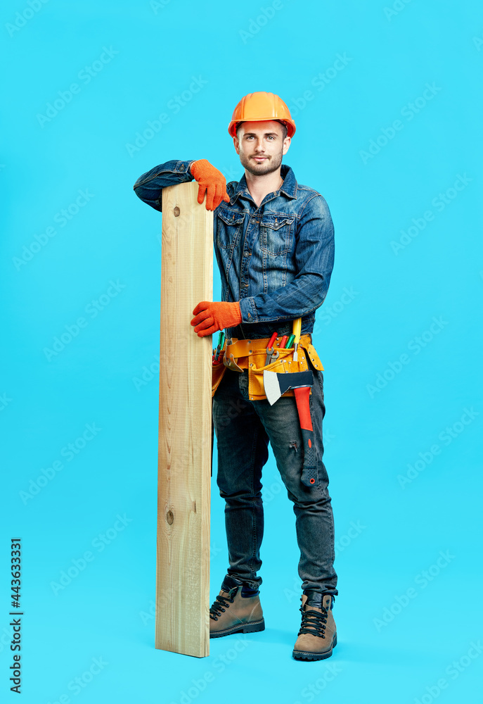 Full length portrait of young handsome carpenter hold pile of lumber woods Full length portrait of young handsome carpenter hold pile of lumber woods