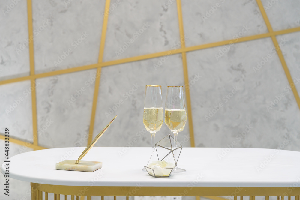 two glasses of champagne on a white table