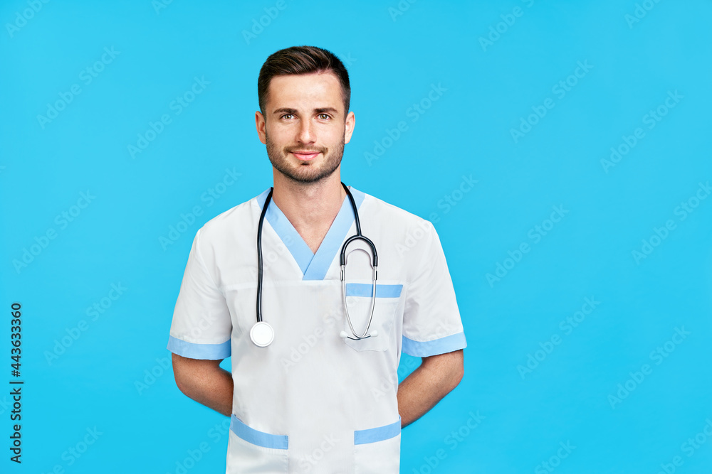Portrait of confident smiling male doctor with stethoscope in medical uniform with copy Portrait of confident smiling male doctor with stethoscope in medical uniform with copy