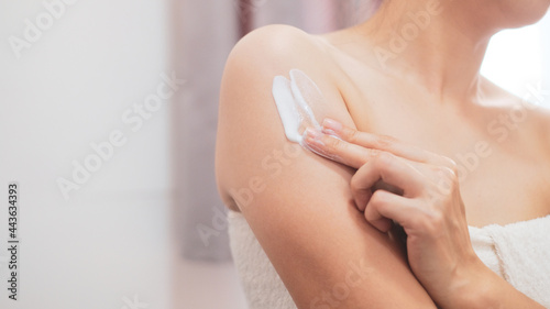 Woman applying natural cream, Woman moisturizing her arm with cosmetic cream, Spa and Manicure concept. © BoszyArtis