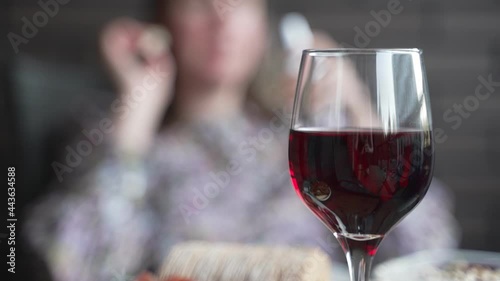 Red wine in the glass and snacks.