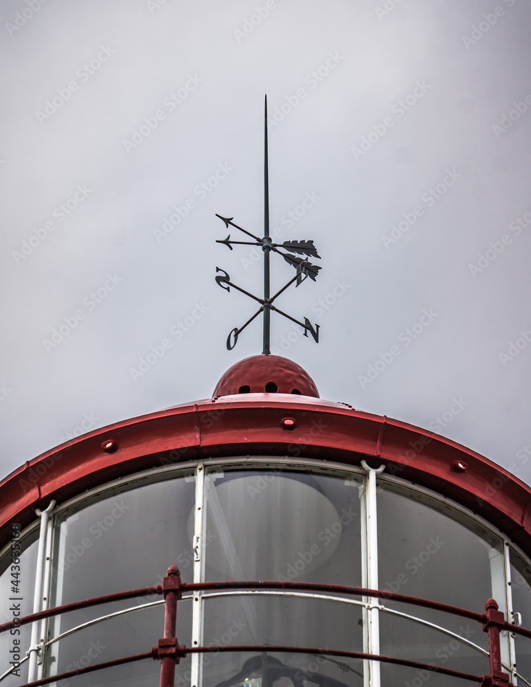 Detail of the Cap de La Madeleine Lighthouse with this close up on the red weathercock of this lighthouse located in Gaspesie (Quebec, Canada)