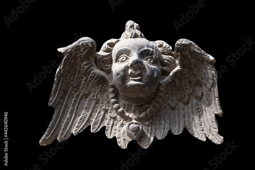 Antique statue of angel with wings Ancient statue isolated on black background.
