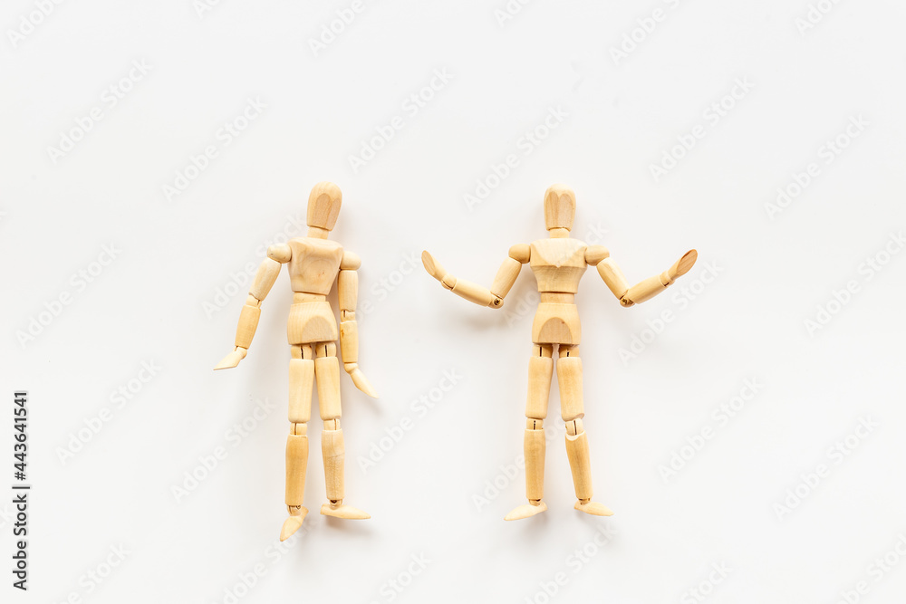 Two wooden figure connection - emotional communication concept Two wooden figure connection - emotional communication concept