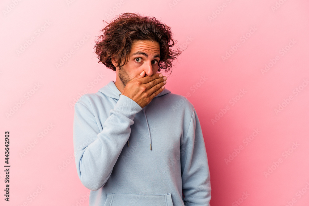 Young caucasian man isolated on pink bakcground covering mouth with hands looking worried. Young caucasian man isolated on pink bakcground covering mouth with hands looking worried.