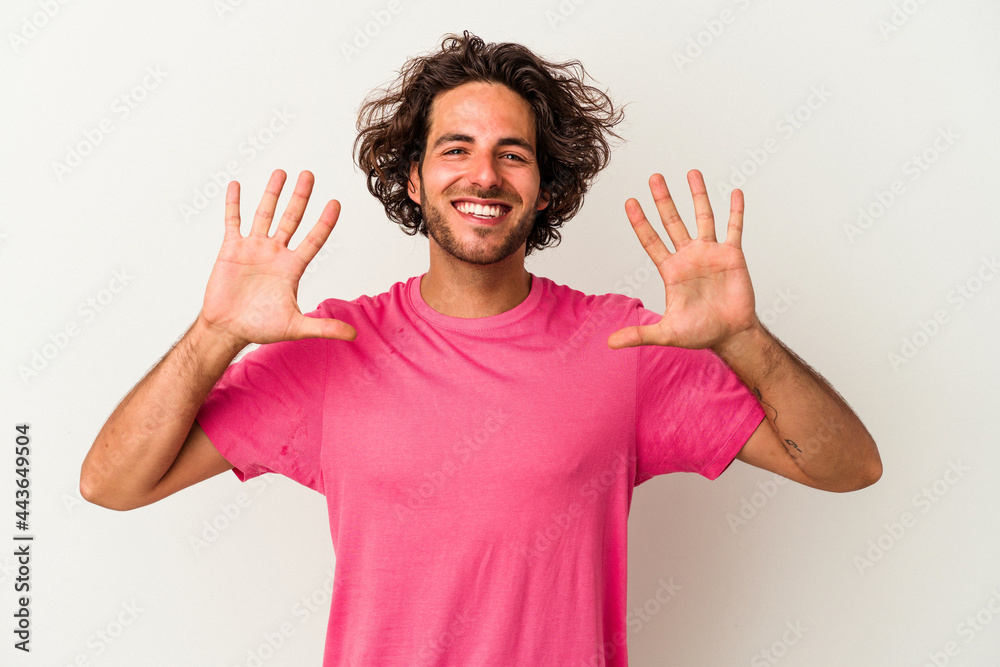 Fototapeta premium Young caucasian man isolated on white background showing number ten with hands.