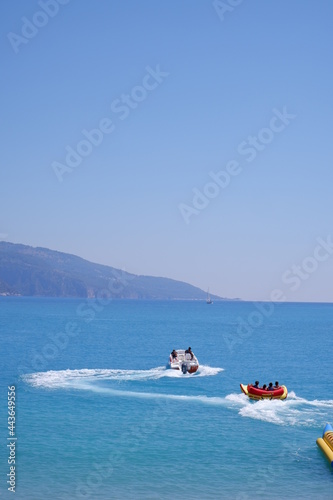 Mugla , Turkey - June 18th 2021 : tourists enjoying extreme sea sport with view of Oludeniz sea 