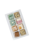 Assorted Turkish delight in a plastic box isolated on a white background.