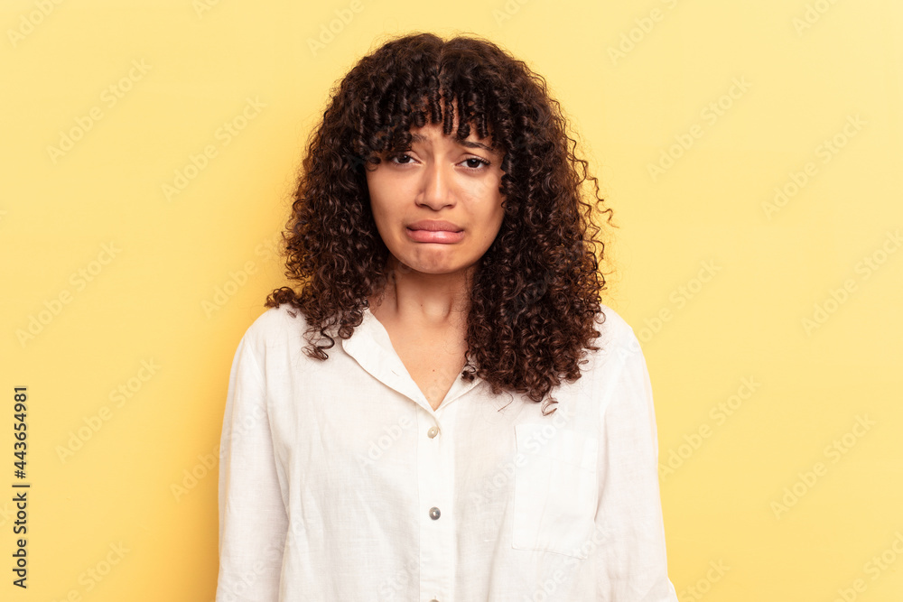 Young mixed race woman isolated on yellow background sad, serious face, feeling miserable and displeased. Young mixed race woman isolated on yellow background sad, serious face, feeling miserable and displeased.