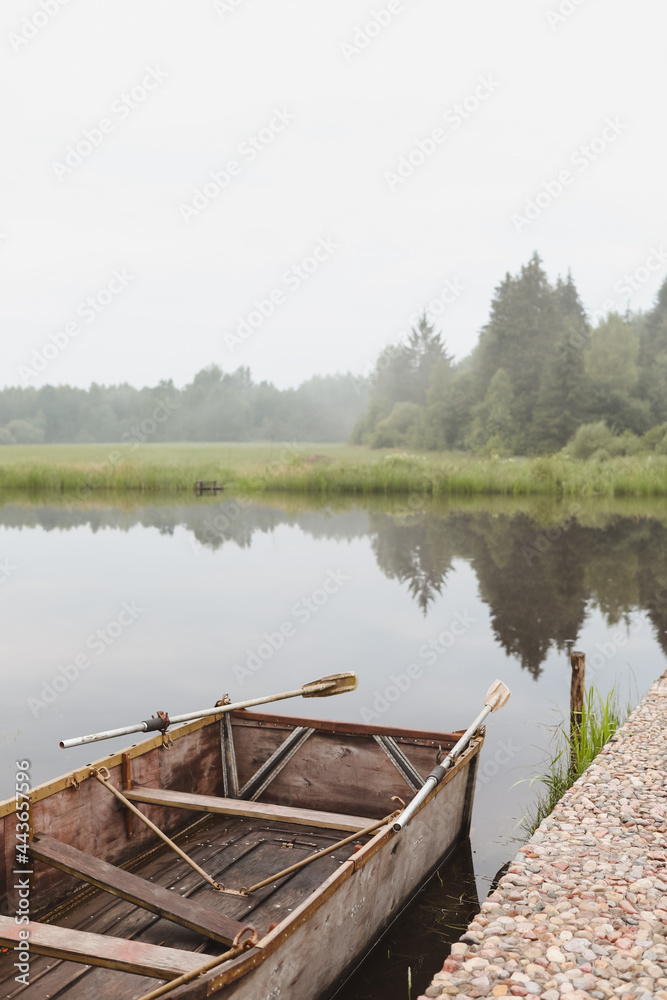 wooden boat by the pier on the lake wooden boat by the pier on the lake