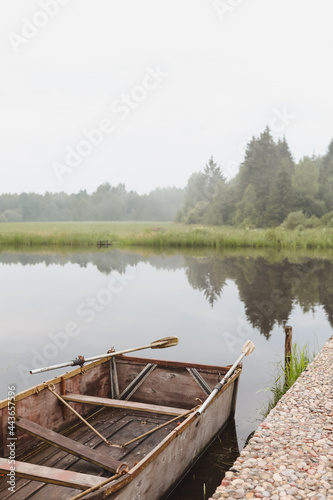 wooden boat by the pier on the lake