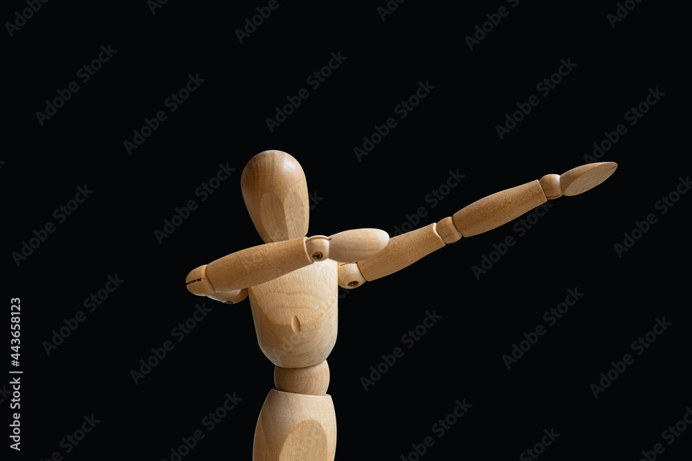 do the dab. wooden puppet on black background. isolated image do the dab. wooden puppet on black background. isolated image
