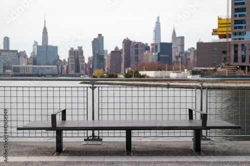 Empty Bench on the Greenpoint Brooklyn Riverfront along the East River with the Manhattan Skyline in the background