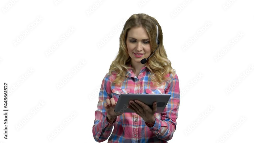 Beautiful consultant of call center in headphones with a tablet. Beautiful consultant of call center in headphones with a tablet.