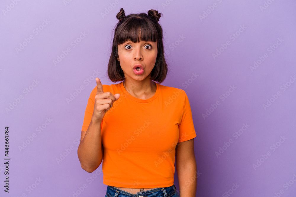 Young mixed race woman isolated on purple background having an idea, inspiration concept. Young mixed race woman isolated on purple background having an idea, inspiration concept.