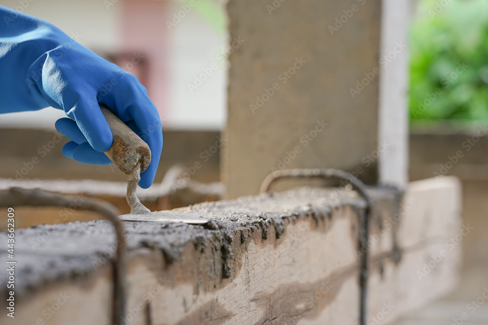 Cement or mortar, Cement mix with a trowel in a hand on the brick for  construction work. Stock Photo