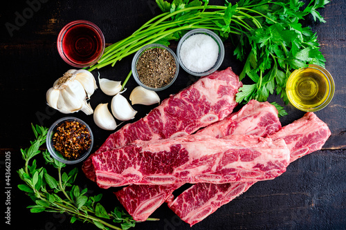 Argentinean-Style Grilled Short Ribs With Chimichurri Ingredients: Flanken beef spare ribs, parsley, and other raw ingredients