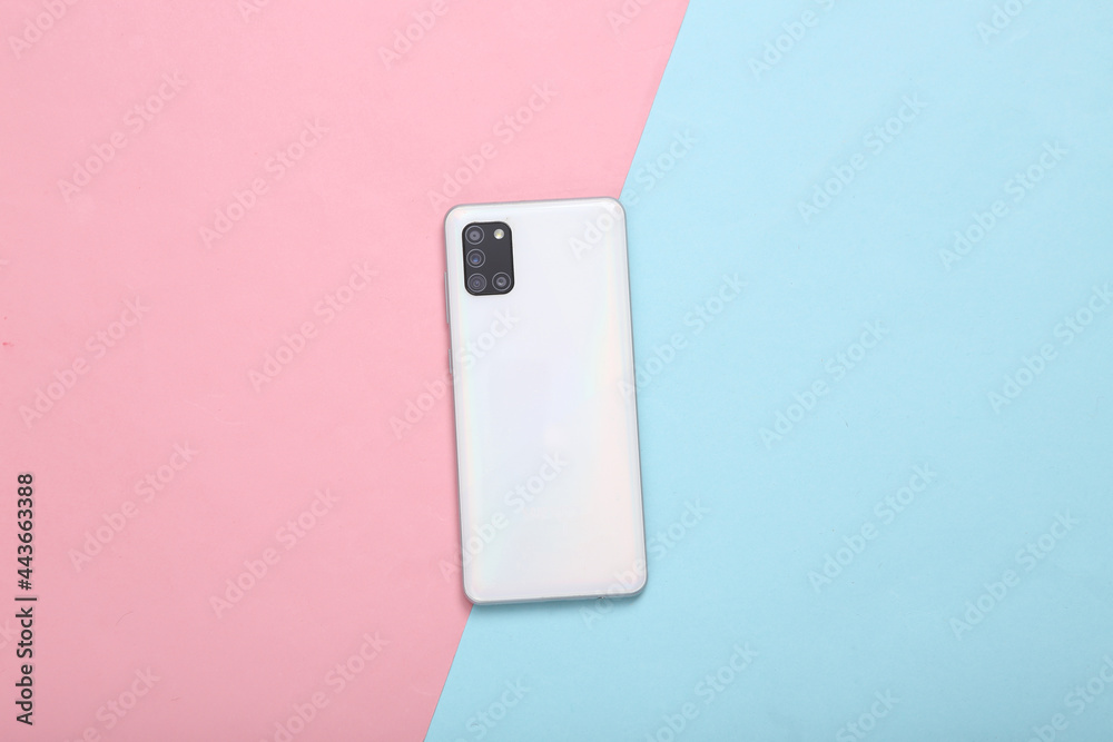 Back side of modern smartphone with four cameras on blue pink pastel background Back side of modern smartphone with four cameras on blue pink pastel background