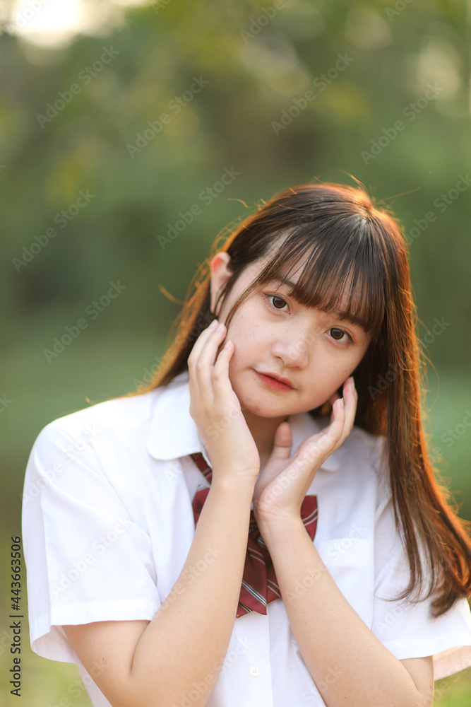 beautiful asian japanese school girl uniform looking at park outdoor