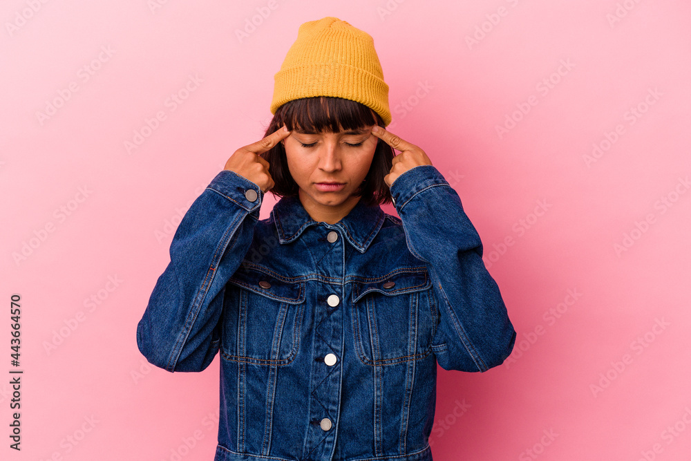Young mixed race woman isolated on pink background focused on a task, keeping forefingers pointing head. Young mixed race woman isolated on pink background focused on a task, keeping forefingers pointing head.