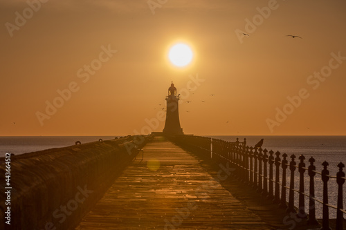 Tynemouth Pier and the Lighthouse with a beautiful vibrant sunrise