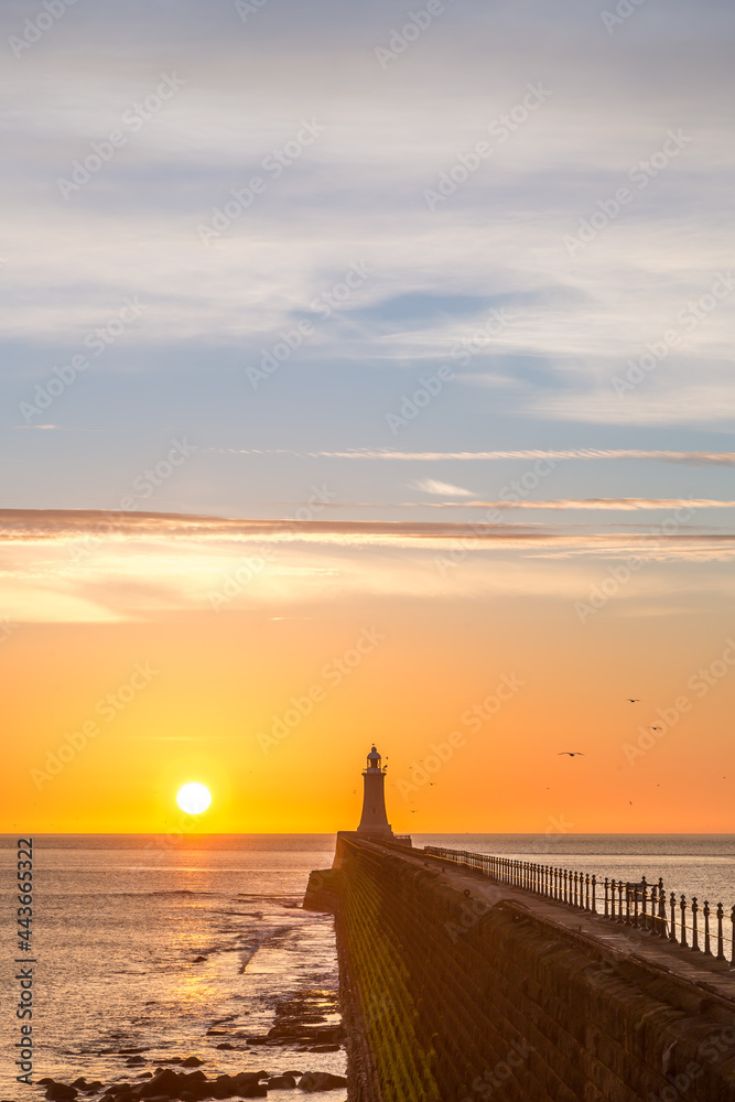Tynemouth Pier and the Lighthouse with a beautiful vibrant sunrise