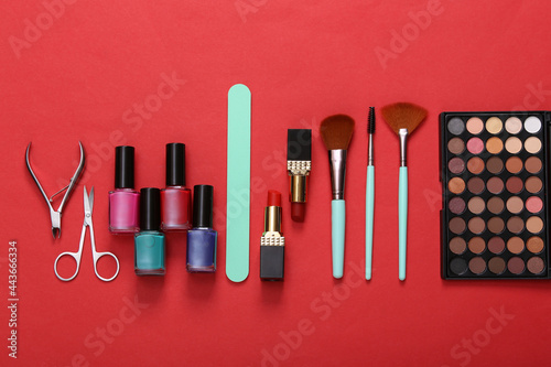 Beauty, make-up and manicure products on a red background. Top view. Flat lay