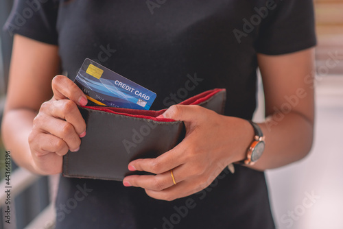 hand taking credit card out of pocket