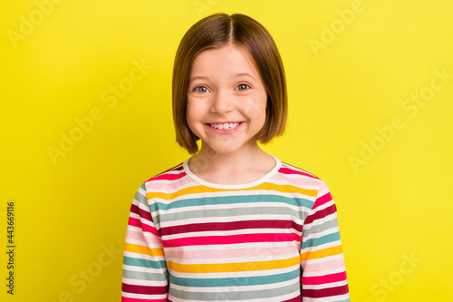 Photo portrait little girl in striped clothes smiling isolated bright yellow color background