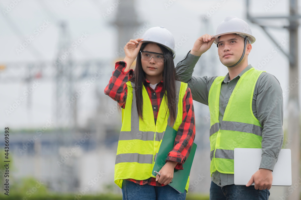 Two engineer working at power plant,Work together happily,Help each other analyze the problem,Consult about development guidelines Two engineer working at power plant,Work together happily,Help each other analyze the problem,Consult about development guidelines