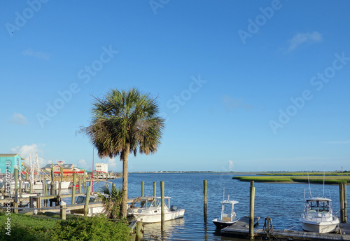 View of Southport NC riverfront with boat docks and seafood restaurants © zimmytws