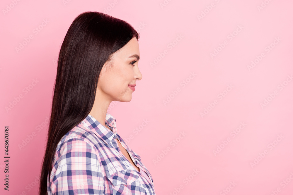 Side profile photo portrait of girl in casual clothes smiling looking blank space isolated on pastel pink color background Side profile photo portrait of girl in casual clothes smiling looking blank space isolated on pastel pink color background