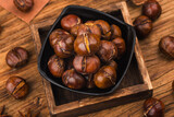 Chestnuts on a wooden background.