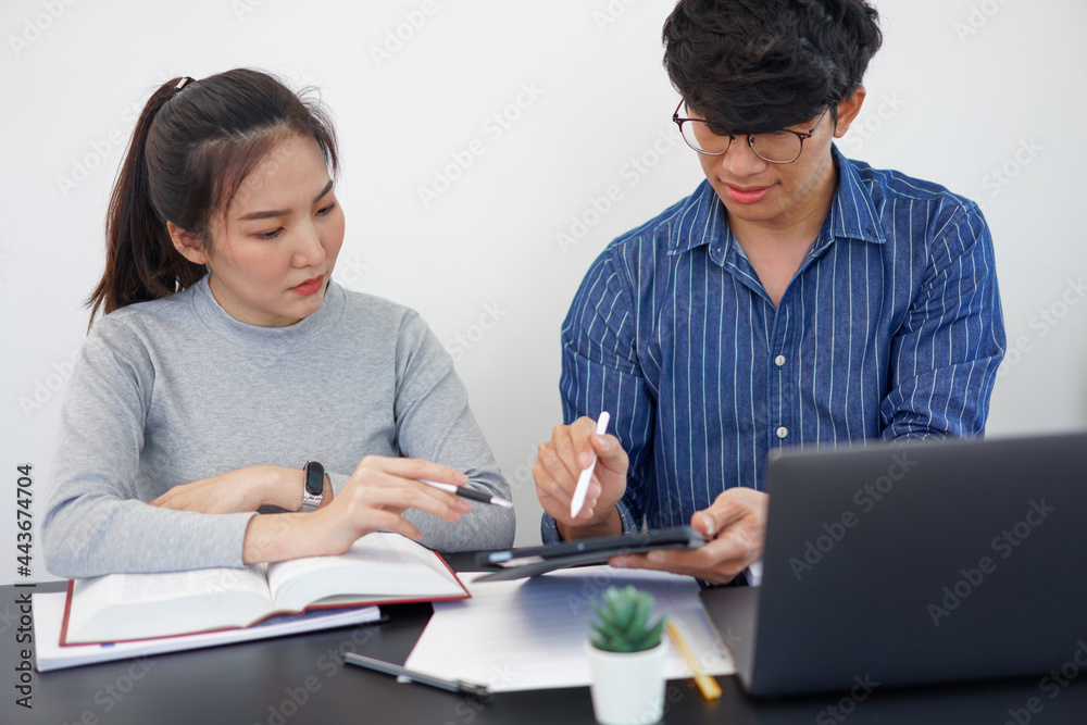 Office work concept a pretty businesswoman asking for an idea about the marketing strategies from her business partner