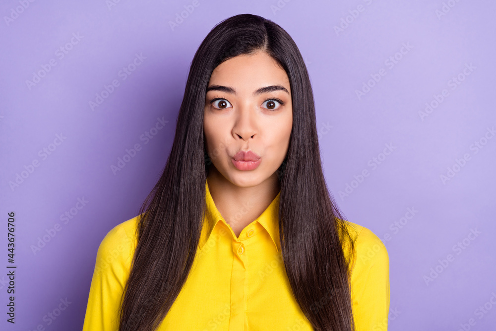 Fototapeta premium Photo of sweet brown hairdo young lady blow kiss wear yellow shirt isolated on purple color background