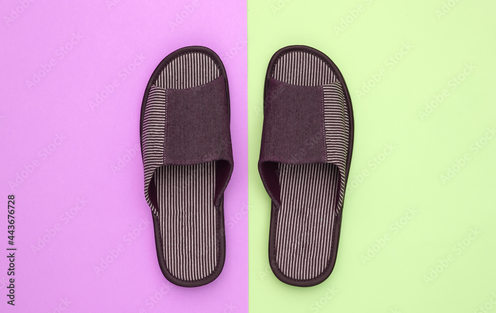 Men's sleeping room slippers on pink green pastel background. Top view Men's sleeping room slippers on pink green pastel background. Top view