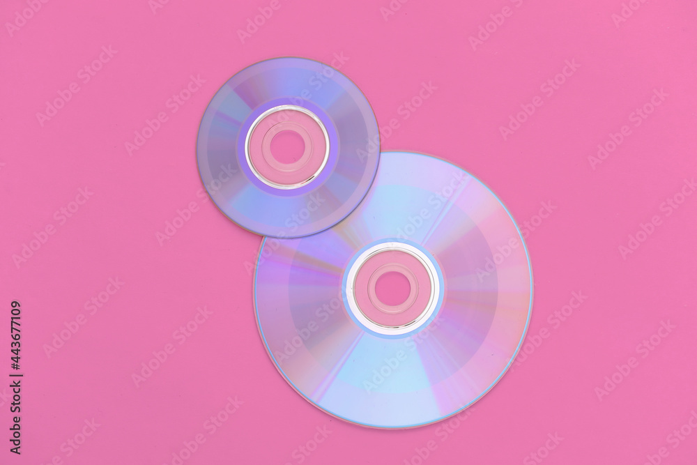 Compact disсs on pink background. Top view Compact disсs on pink background. Top view
