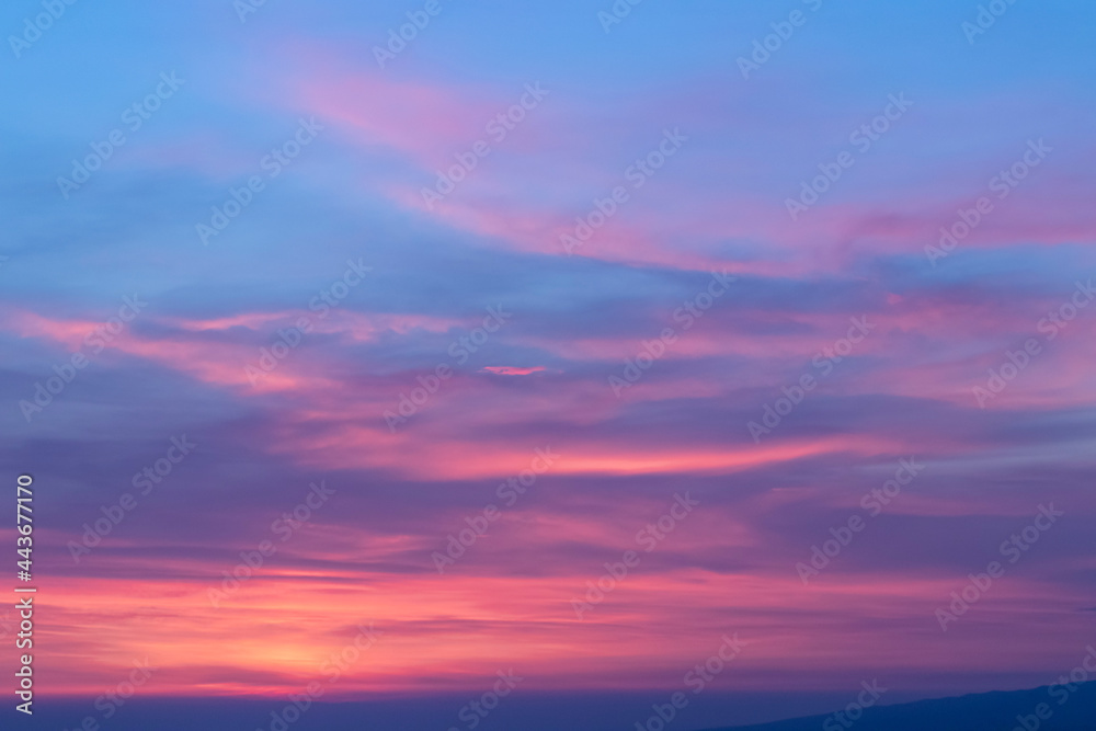 View of pink-purple clouds before sunrise