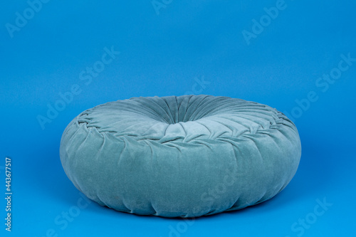 Close up of a blue cushion against a blue background