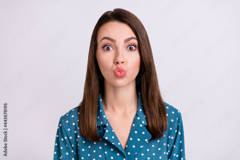 Fototapeta premium Photo of flirty brunette hair young lady blow kiss wear blue shirt isolated on grey color background