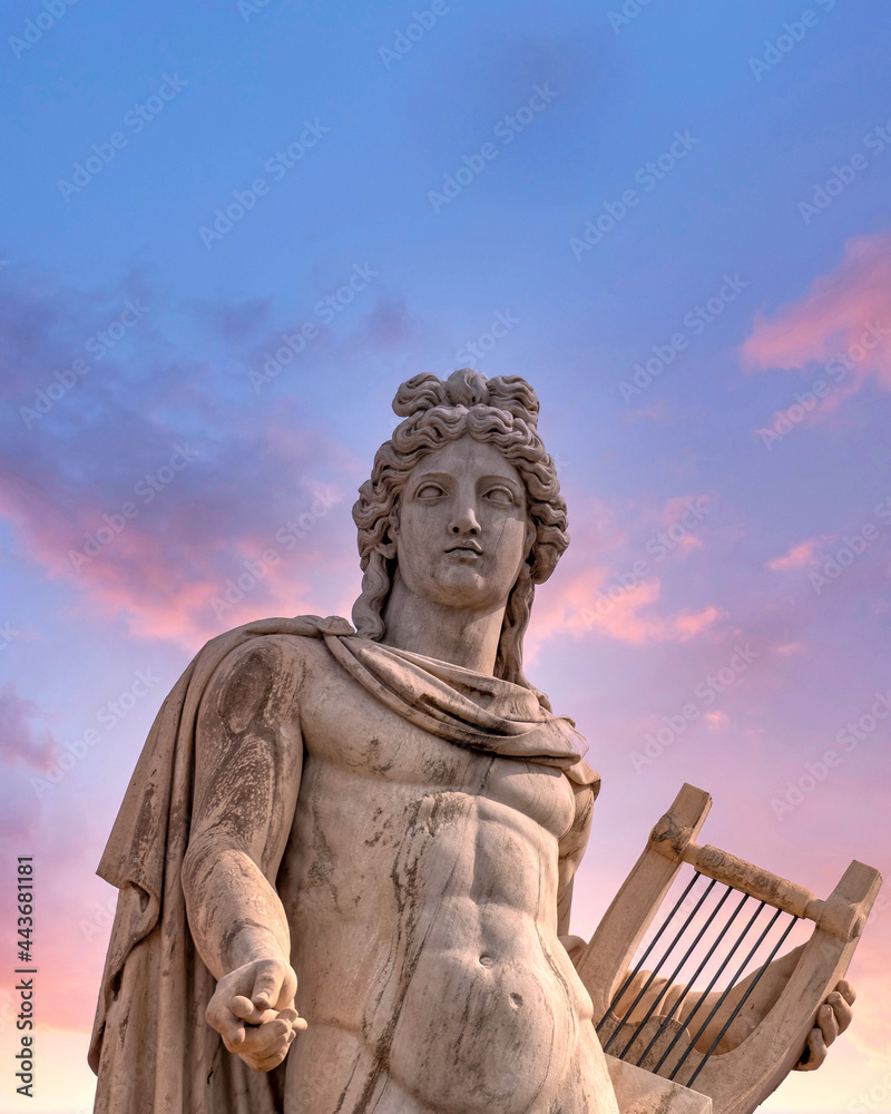 Apollo ancient Greek god statue under dramatic sky, Athens Greece